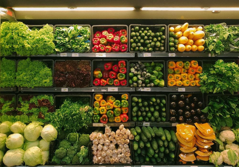 Wet market stalls before eight with vegetables under warm lights